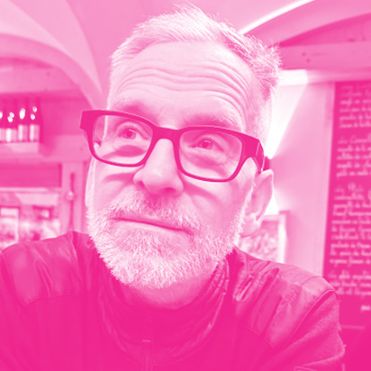 Paul Kruszewski's headshot with a hot pink filter.