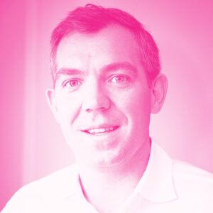 James Rivett's headshot with a hot pink filter.